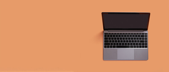 Fototapeta na wymiar Top view of modern laptop isolated on orange background. Copy space