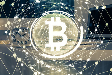 Multi exposure of blockchain theme hologram and table with computer background. Concept of bitcoin crypto currency.