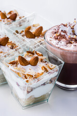 Dessert with different layers in a glass with chocolate ice cream, almonds