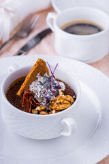 Dessert in a cup with walnuts, pastries, cream and poppy seeds
