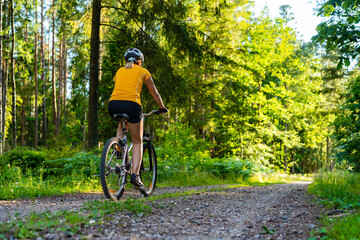 Woman riding bike in forest  © Jacek Chabraszewski