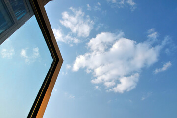 Open window and white big cumulus clouds