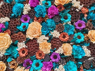 Many artificial flowers background. Flowers are made from natural materials and handmade. colorful wallpaper.