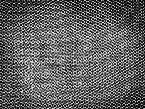 Material black color background. Pattern of black mesh fabric.The surface of net with holes like honeycomb.