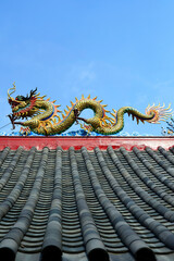 detail of the roof  of chinese temple with dragon