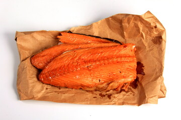 Hot smoked salmon trim and leftovers with bones and fins on white background.