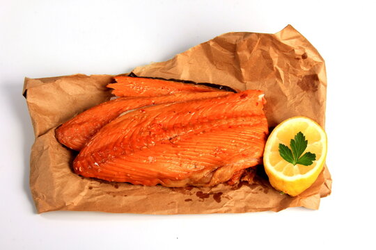 Hot smoked salmon trim and leftovers with bones and fins on white background.