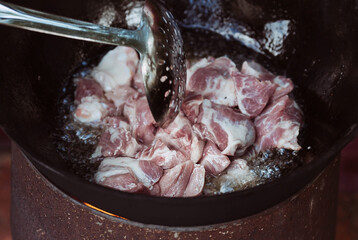 Recipe for traditional oriental pilaf in a cauldron in nature. Cooking. Recipes. Step-by-step photo...