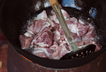 Recipe for traditional oriental pilaf in a cauldron in nature. Cooking. Recipes. Step-by-step photo...