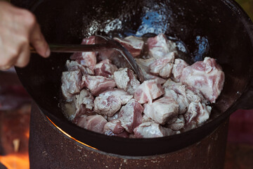Recipe for traditional oriental pilaf in a cauldron in nature. Cooking. Recipes. Step-by-step photo...