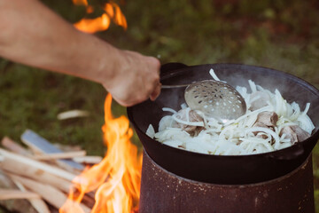 Recipe for traditional oriental pilaf in a cauldron in nature. Cooking. Recipes. Step-by-step photo...