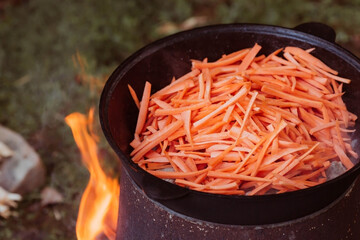 Recipe for traditional oriental pilaf in a cauldron in nature. Cooking. Recipes. Step-by-step photo...