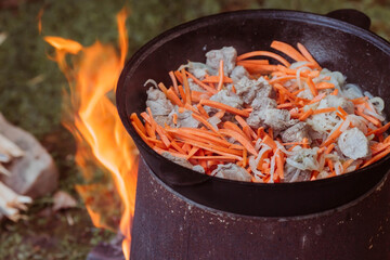 Recipe for traditional oriental pilaf in a cauldron in nature. Cooking. Recipes. Step-by-step photo...