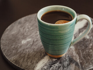 A cup of coffee on a marble board, vintage style