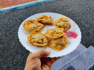 Delicious sweet snacks in a plate taken by a human hand closeup shot