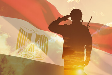 Double exposure of silhouette of a solider and the sunset or the sunrise against flag of Egypt....