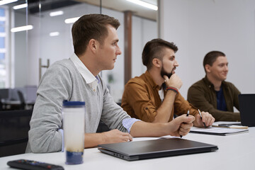 Making great decisions. Team members discuss software features during the meeting in IT office