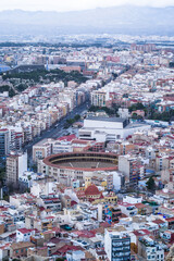 contemporary buildings in the city center against the overcast mountains