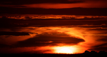 Clouds and orange sunset. Worsening weather conditions. Emergency. Abstract natural background.