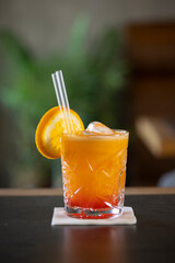 Squeezed orange juice with ice cubes in a glass