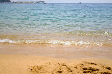 Fototapeta na wymiar Sea quiet wave on a quiet scene in Mediterranean Beach in Catalonia