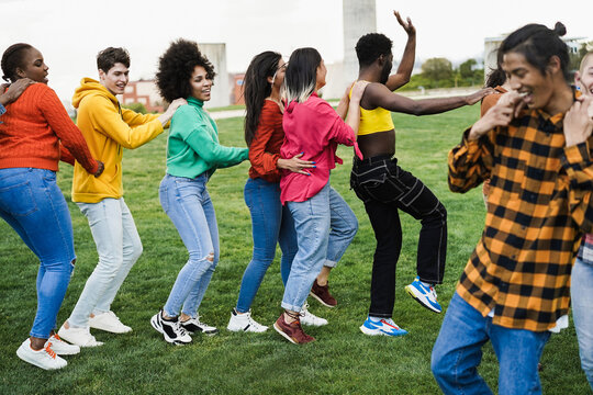 Group Of Multiracial People Dancing Together Outdoor - Focus On Girl Wearing Pink Shirt