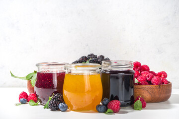 Assortment of berries and fruits jams in jars