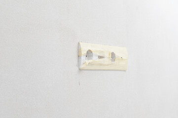 White sockets on a white wall, a socket for a television antenna.