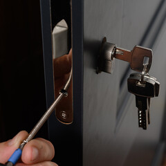 Installation of lock and door handle to interior doors, locksmith works with doors. - obrazy, fototapety, plakaty