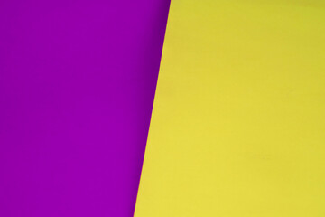 Dark vs light abstract Background with plain subtle smooth de saturated yellow purple colours parted into two