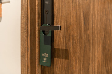 Green door hanger tag on black handle