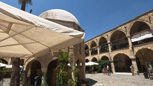 People are walking in the old city of Nicosia. Slow Motion rotate right
