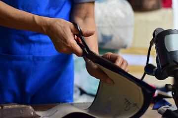 hand with fabric scissors