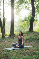 Woman practicing meditation in the forest