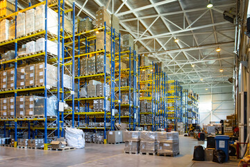 Interior of a modern warehouse storage of retail shop with pallet truck near shelves