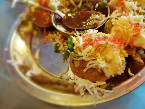 close up of Phuchka common street snack from Bangladesh. Panipuri or Golgappa. It's a round, hollow puri filled with a mixture of tamrind water and other chat items. Dahi or Doi phuchka.