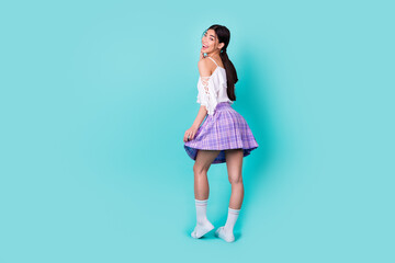 Full length photo of funny pretty lady wear white top walking empty space isolated turquoise color background