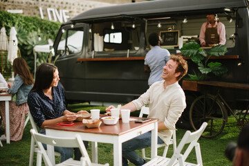 Merry couple laughing at joke during lunch