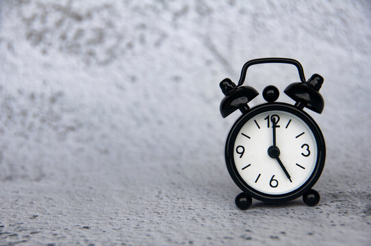 Alarm clock pointing at 5 o'clock with customizable space for ideas or text. Copy space.