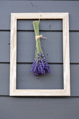 Bouquet of lavender with frame , heart ribbon on wooden background