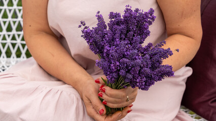 Woman with bouquet of beautiful lavender flowers outdoors, closeup.