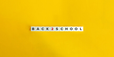 Back to School Banner. Inscription on Block Letter Tiles on Yellow Orange Background. Minimal Aesthetics.