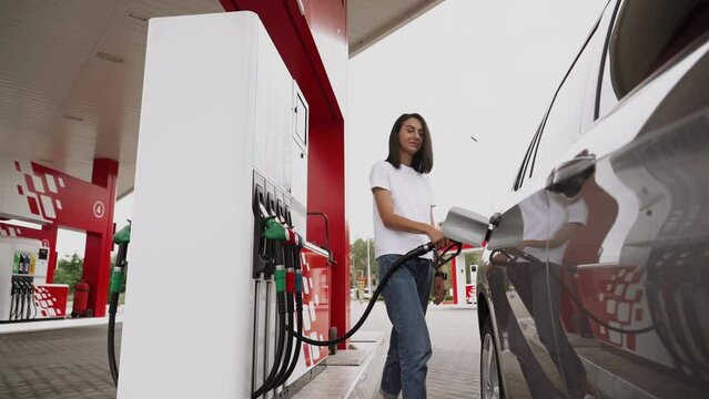 Gas Station Gas Pump Close Up Pump Nozzles At Gas Station Young Beautiful Woman Driver Fills The Car With Gasoline