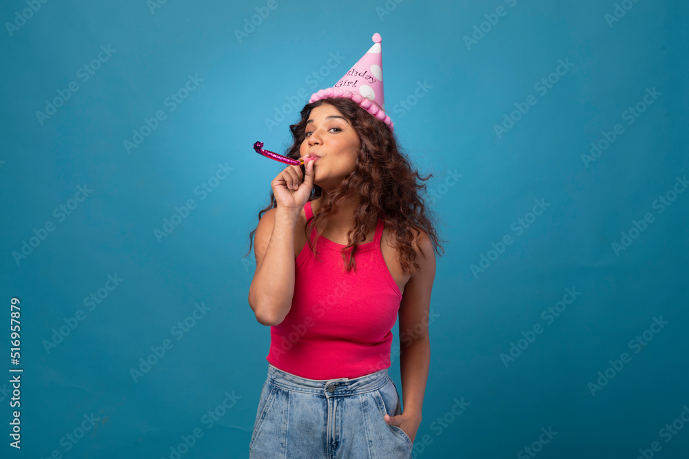 Wall mural Young woman wearing party hat