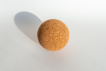 Nice brown cork ball lie on the white gray background.Copy space.