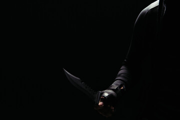Cropped view of african american bandit holding knife isolated on black