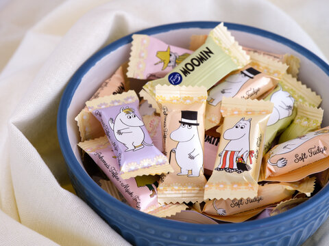 Tambov, Russian Federation - April 27, 2022 A Bowl full of Moomin Soft fudge candies by Fazer. The fudge comes single wrapped, with 9 different characters printed on the wrapper.