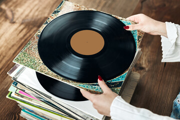 Playing vinyl records. Listening to music from vinyl record player. Retro and vintage music style....