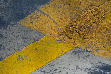 Reflective yellow bands painted on a parking lot pavement