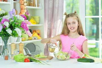 Cute girl preparing delicious fresh salad